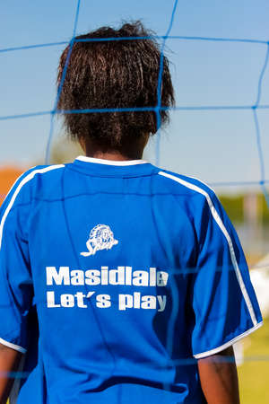 Johannesburg, South Africa - June 29 2009:  Diverse children playing soccer football at school
