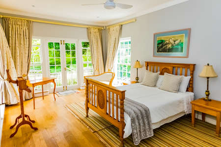 Cape Town, South Africa - February 6, 2020: Inside interior of bedroom with wooden floors in up-market house in the suburbsのeditorial素材