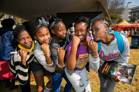 Johannesburg, South Africa - June 13, 2015: Group of young African girls flexing arm muscles in show of feminist powerのeditorial素材