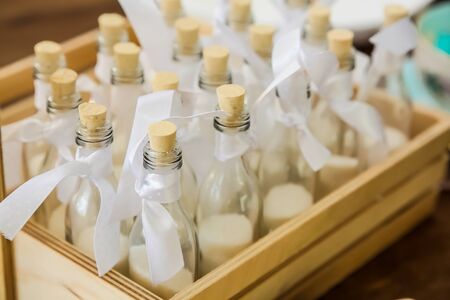 Small ornamental jars with cork tops and ribbons for display purposesの写真素材