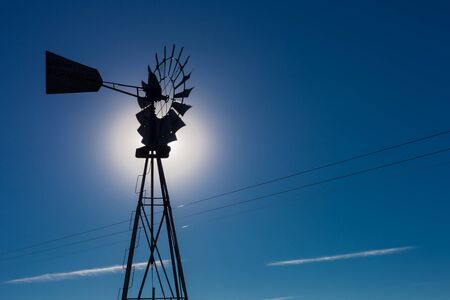 Wind pump windmill silhouette in the Karoo desert of South Africaの写真素材