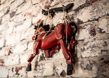 Selective Focus Abstract image of a Wooden String Puppet Horse hanging on a wallの写真素材