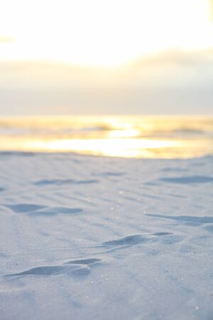 Footprints in the sand on a beach at sunset in Cape Town South Africa
