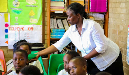 Soweto, South Africa - October 26 2011: Young African Children and Teachers in Primary School Classroomのeditorial素材