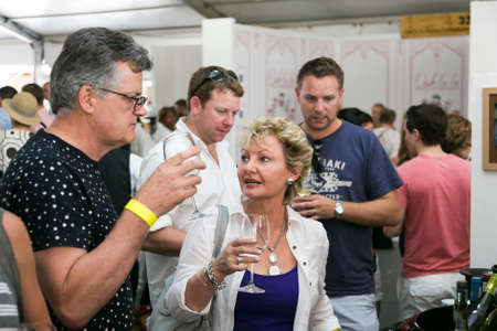 Johannesburg, South Africa - November 8 2014: Middle aged couple eating, drinking and generally...