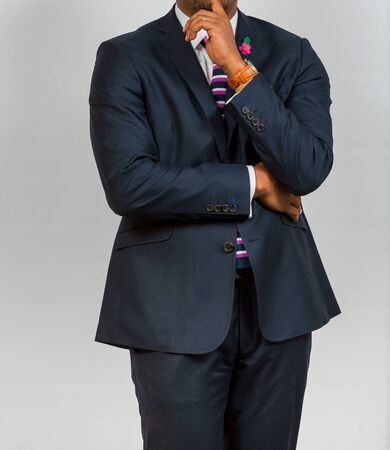 Close-up cropped African Black hands and arms of businessman in a suit with hand on chinの写真素材