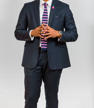 Close-up cropped African Black hands and arms of businessman in a suit with hands in frontの写真素材