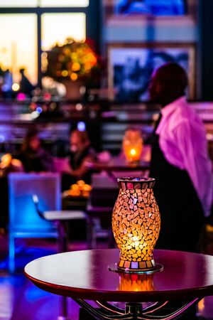 Gala Dinner or cocktail party Event Decor in dark room with candles and glass lamps 