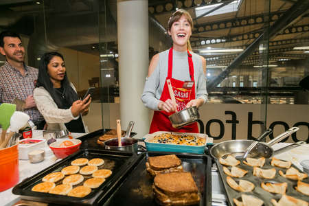 Johannesburg, South Africa - October 05, 2017: Diverse young women learning to cook and bake at a...