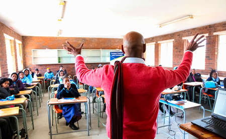 Johannesburg, South Africa - July 29 2011: African High School Children and teacher in Classroom...