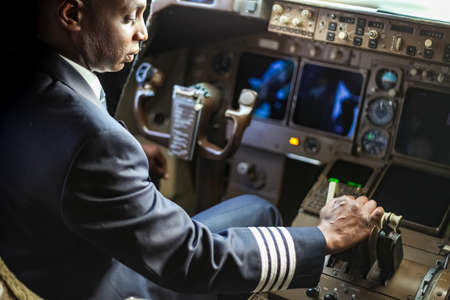Johannesburg, South Africa - May 08 2012: Over the Shoulder of an African Pilot in a Jumbo Cockpitのeditorial素材