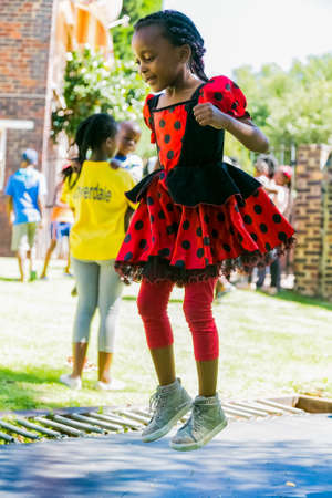 Johannesburg, South Africa - December 14, 2017: Young African children jumping and playing on a trampolineのeditorial素材