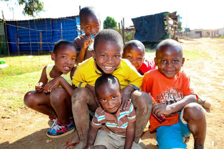 Soweto, South Africa - September 7, 2011: Small group of young African children posing for a photo and displaying friendship and joy in a Soweto Townshipのeditorial素材