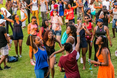 Johannesburg, South Africa - September 11, 2015: Crowd of diverse young people dancing and having fun at day time open air concertのeditorial素材