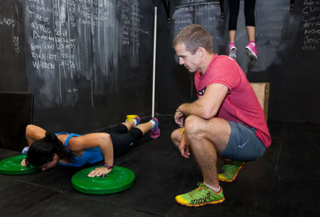 Johannesburg, South Africa - March 11, 2013: Personal Trainer giving fitness instruction at a Crossfit group classのeditorial素材