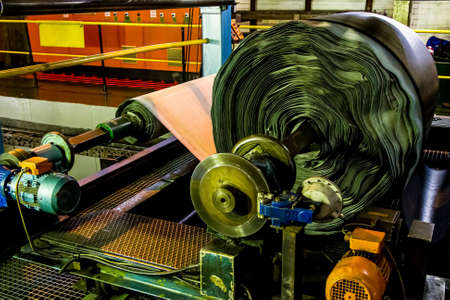 Johannesburg, South Africa - October 16, 2012: Close up of a roll of rubber on a machine in a conveyor belt factoryのeditorial素材