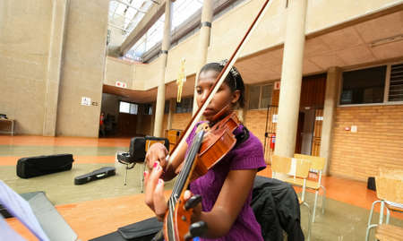 Johannesburg, South Africa - August 28 2010: Diverse youth at music school orchestraのeditorial素材