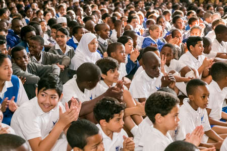 Johannesburg, South Africa - September 10, 2015: Young diverse school children sitting on the floor at a morning assemblyのeditorial素材