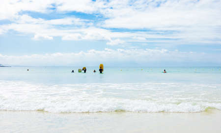 Cape Town, South Africa - March 13 2019: Kids Swimming on Fish Hoek beach on a cloudy dayのeditorial素材