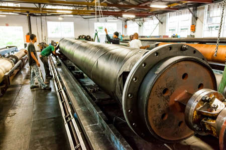 Johannesburg, South Africa - October 19, 2012: Diverse workers inside a rubber and pipe fabrication assembly line in a factoryのeditorial素材