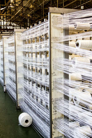 Johannesburg, South Africa - October 16, 2012: Cotton Thread Bobin on a copwinder weft assembly line loomのeditorial素材
