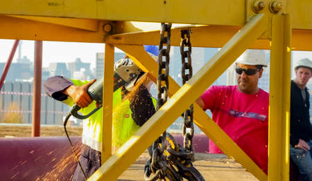 Johannesburg, South Africa - June 06 2010: Tradesman working with an angle grinder on a building...