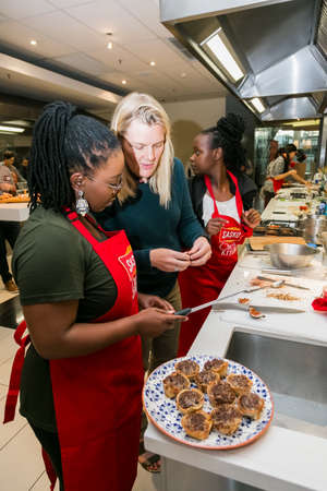 Johannesburg, South Africa - October 05, 2017: Diverse young women learning to cook and bake at a cooking classのeditorial素材