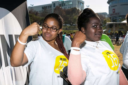 Johannesburg, South Africa - June 13, 2015: Group of young African girls flexing arm muscles in show of feminist powerのeditorial素材