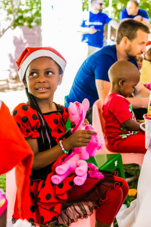 Johannesburg, South Africa - December 14, 2017: Young African girl playing with a plastic doll toy ponyのeditorial素材