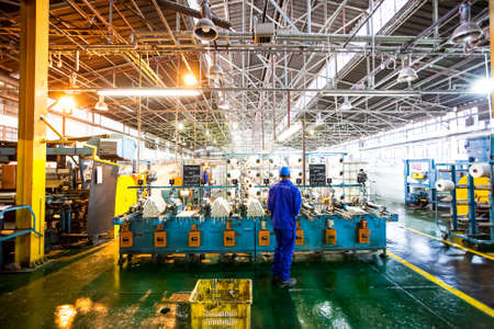 Johannesburg, South Africa - October 16, 2012: African factory worker on a copwinder weft assembly line loomのeditorial素材