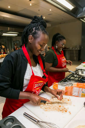 Johannesburg, South Africa - October 05, 2017: Young African women learning to cook and bake at a cooking classのeditorial素材