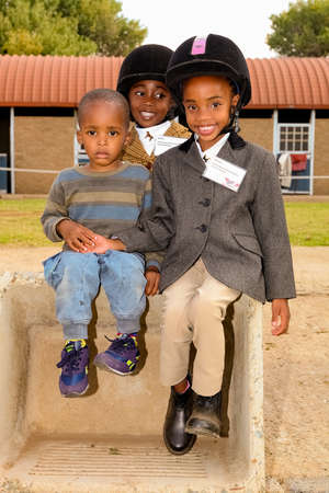 Soweto, South Africa - April 16, 2012: Young African horse riding kids at equestrian training schoolのeditorial素材