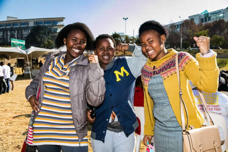 Johannesburg, South Africa - June 13, 2015: Group of young African girls flexing arm muscles in show of feminist powerのeditorial素材