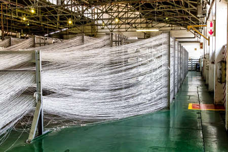 Johannesburg, South Africa - October 16, 2012: Cotton Thread lines for a copwinder weft assembly line loomのeditorial素材