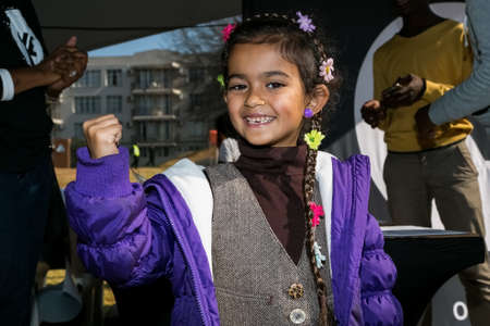 Johannesburg, South Africa - June 13, 2015: Young Indian girl flexing arm muscles in show of...