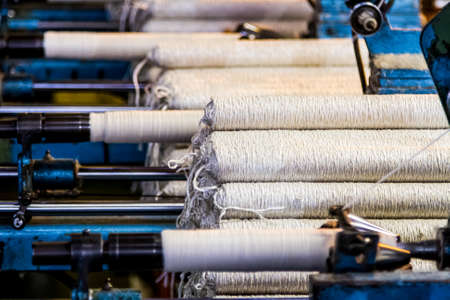 Johannesburg, South Africa - October 16, 2012: Cotton Thread Bobin on a copwinder weft assembly line loomのeditorial素材