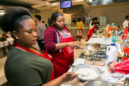 Johannesburg, South Africa - October 05, 2017: Young African women learning to cook and bake at a cooking classのeditorial素材