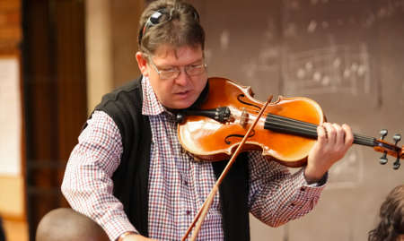 Johannesburg, South Africa - August 28 2010: Teacher at music school orchestra classのeditorial素材