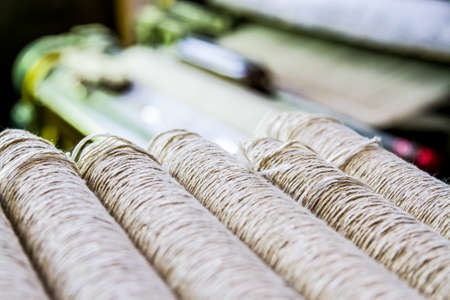 Johannesburg, South Africa - October 16, 2012: Cotton Thread Bobin on a copwinder weft assembly line loomのeditorial素材