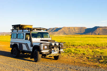 Karoo, South Africa - March 17 2019: Old Land Rover Defender parked beside a national highway in the...