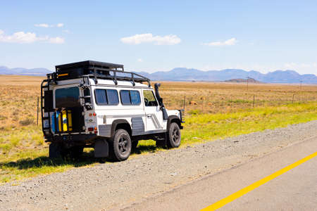 Karoo, South Africa - March 17 2019: Old Land Rover Defender parked beside a national highway in the countryside of South Africaのeditorial素材