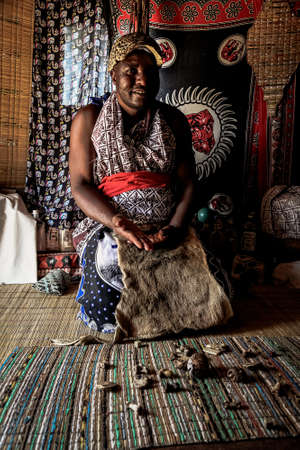 Sabi Sabi, South Africa - May 5, 2012: African Male Traditional Healer known as a Sangoma or witch-doctor performing a spiritual readingのeditorial素材