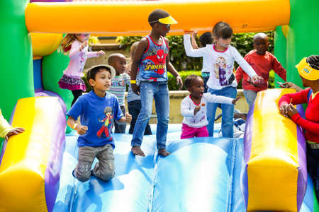Johannesburg, South Africa - September 22, 2012: Diverse children having fun on a jumping castle at...