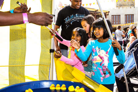 Johannesburg, South Africa - September 22, 2012: Children playing carnival games with rubber ducks...