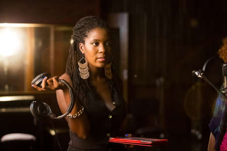 Johannesburg, South Africa - February 18, 2014: African Artist Nancy G, Swaziland singing in a SABC recording studioのeditorial素材