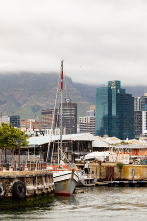 Cape Town, South Africa - December 14, 2020: Various kinds of boats in VA Waterfront Harbor on a cloudy dayのeditorial素材