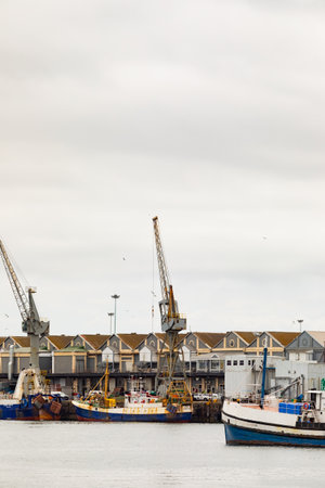 Cape Town, South Africa - December 14, 2020: Various kinds of boats in VA Waterfront Harbor on a cloudy dayのeditorial素材