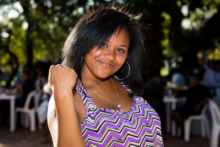 Johannesburg, South Africa - April 30, 2015: Young African girl flexing arm muscles in show of feminist powerのeditorial素材