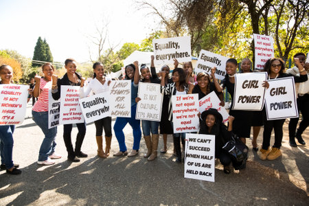 Johannesburg, South Africa - April 30, 2015: Staged Woman's protest march in suburban street to be used in music video for charity purposesのeditorial素材