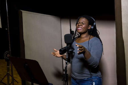 Johannesburg, South Africa - April 28, 2015: Judith Sephuma, South African singer recording vocal part on Afro-pop song in studioのeditorial素材